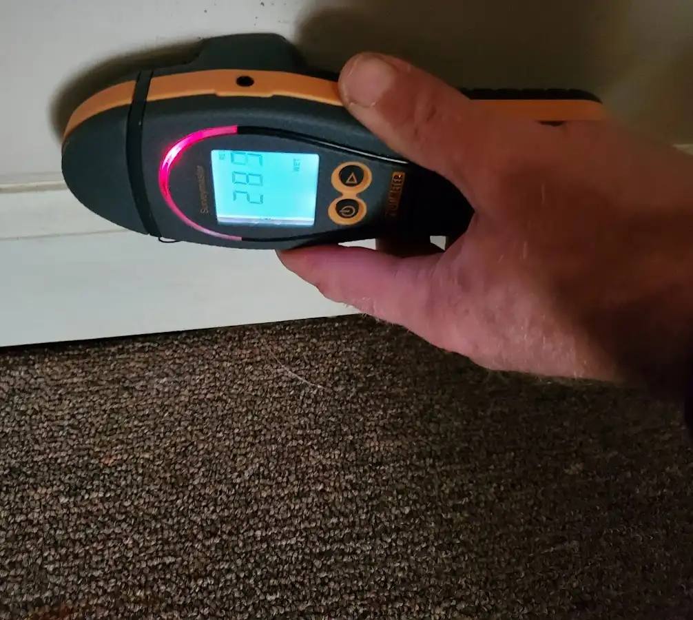 Moisture detection at baseboard during Storm Damage Restoration in Lady Lake